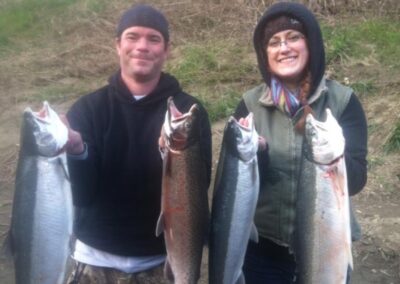 Two successful fisherman with their daily limits of steelhead